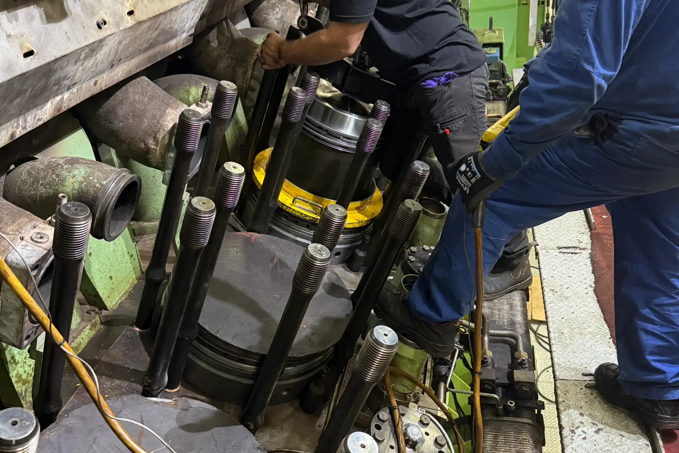 Hydraulic tensioning tools in use on a marine engine cylinder head